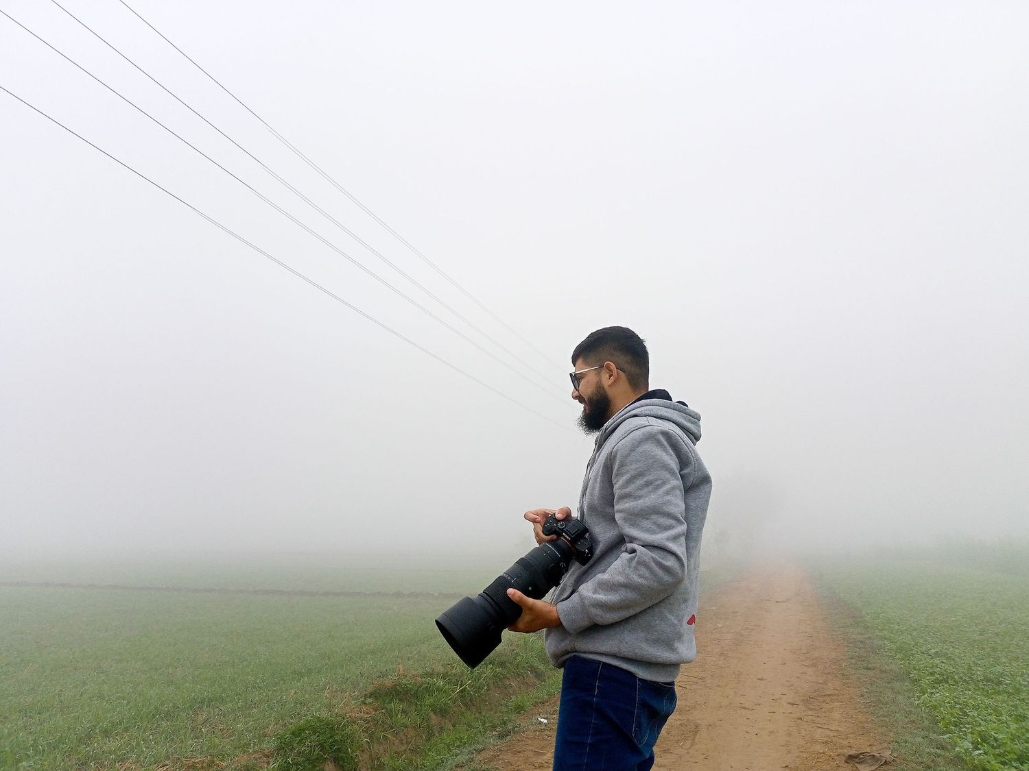 A boy holding a sony camera.