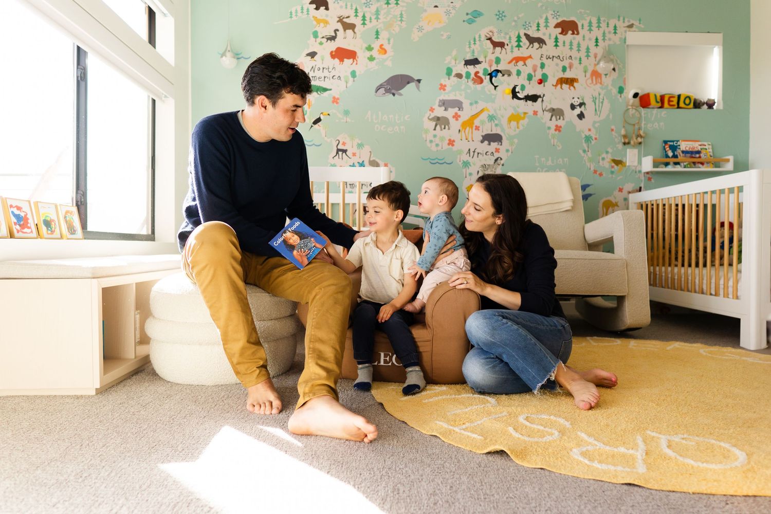 Playful moments captured in a child's room with colorful wall decorations and natural lighting.