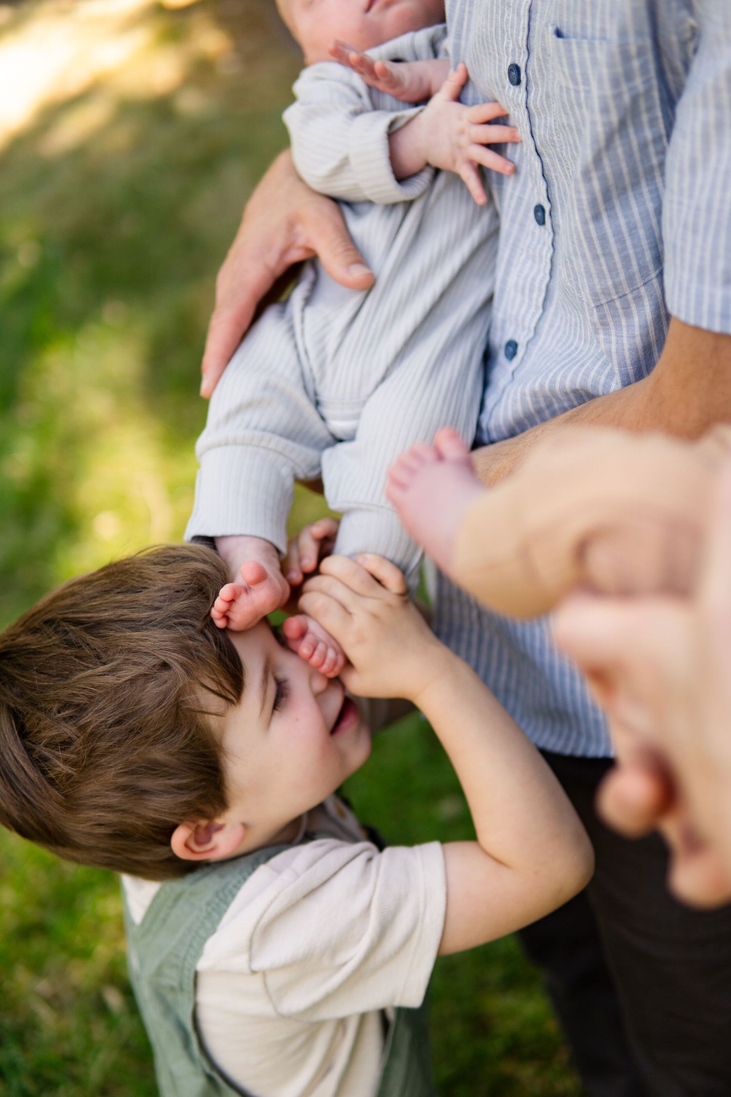 Playful family interaction captured in outdoor setting.