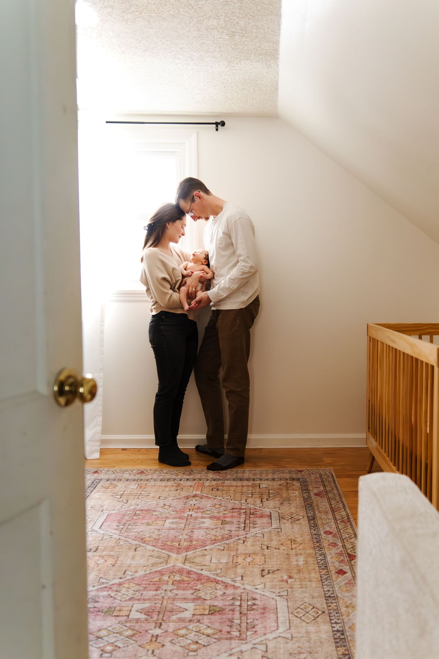 Intimate family moment captured in sequence against white walls and patterned carpet.