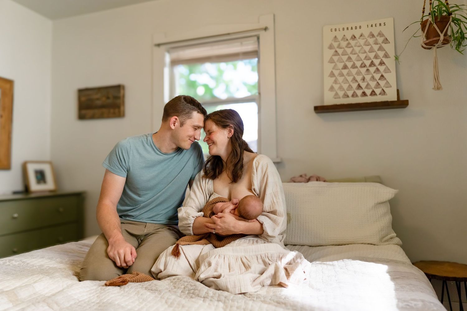 Family bonding moment captured on a cozy bed with soft lighting.
