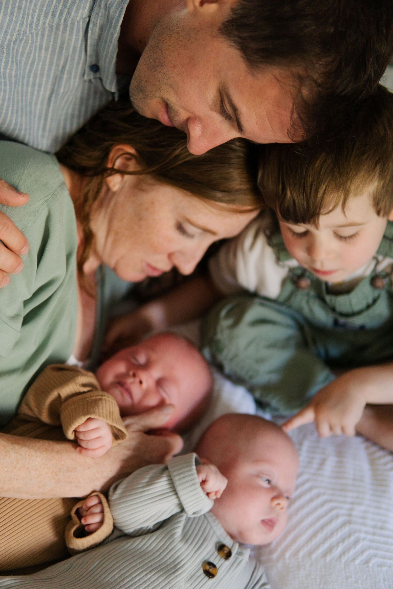 Family cuddle time with baby shown in progressive intimate shots.