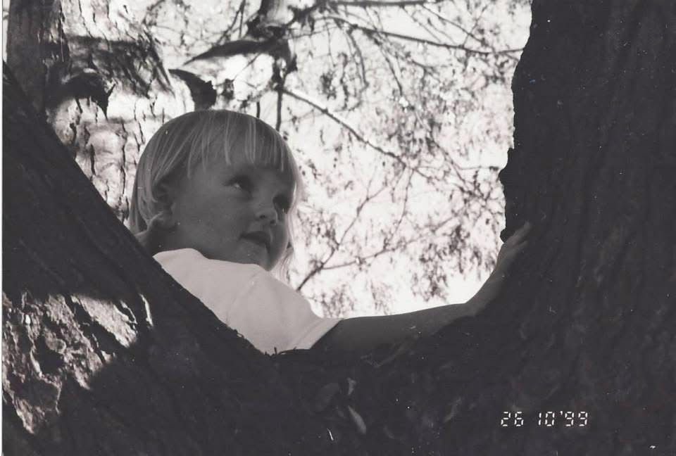 Black and white portrait series showing playful candid moments in natural light.