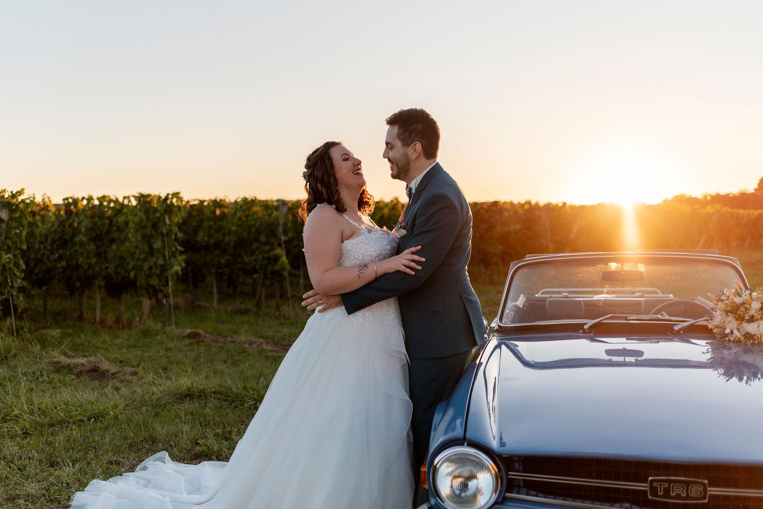 Romantic sunset wedding photo shoot in a scenic outdoor setting with warm golden light.