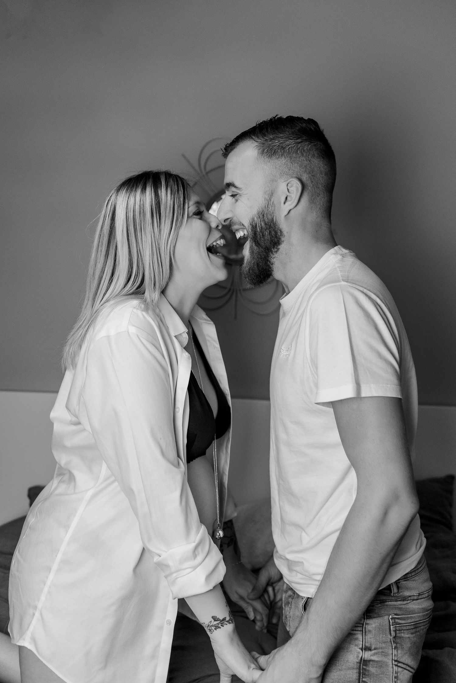 A romantic black and white photo sequence showing a couple in white shirts sharing tender moments.