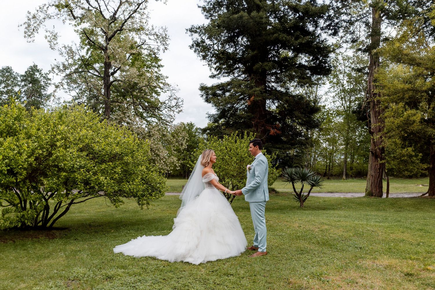 Wedding photos captured in a lush green park setting with natural lighting.