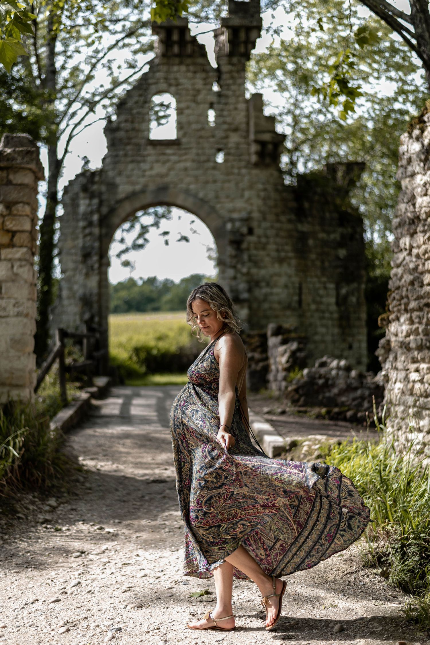 A sequence of photos showing someone posing in a patterned dress among stone ruins and archways.