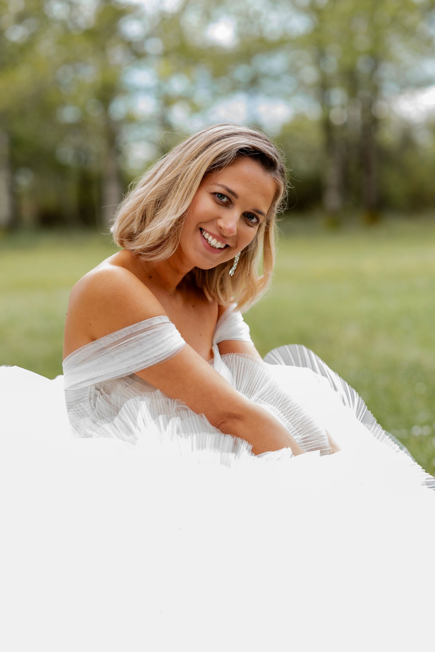 Bridal portrait series showing elegant poses in a white gown against a natural backdrop.