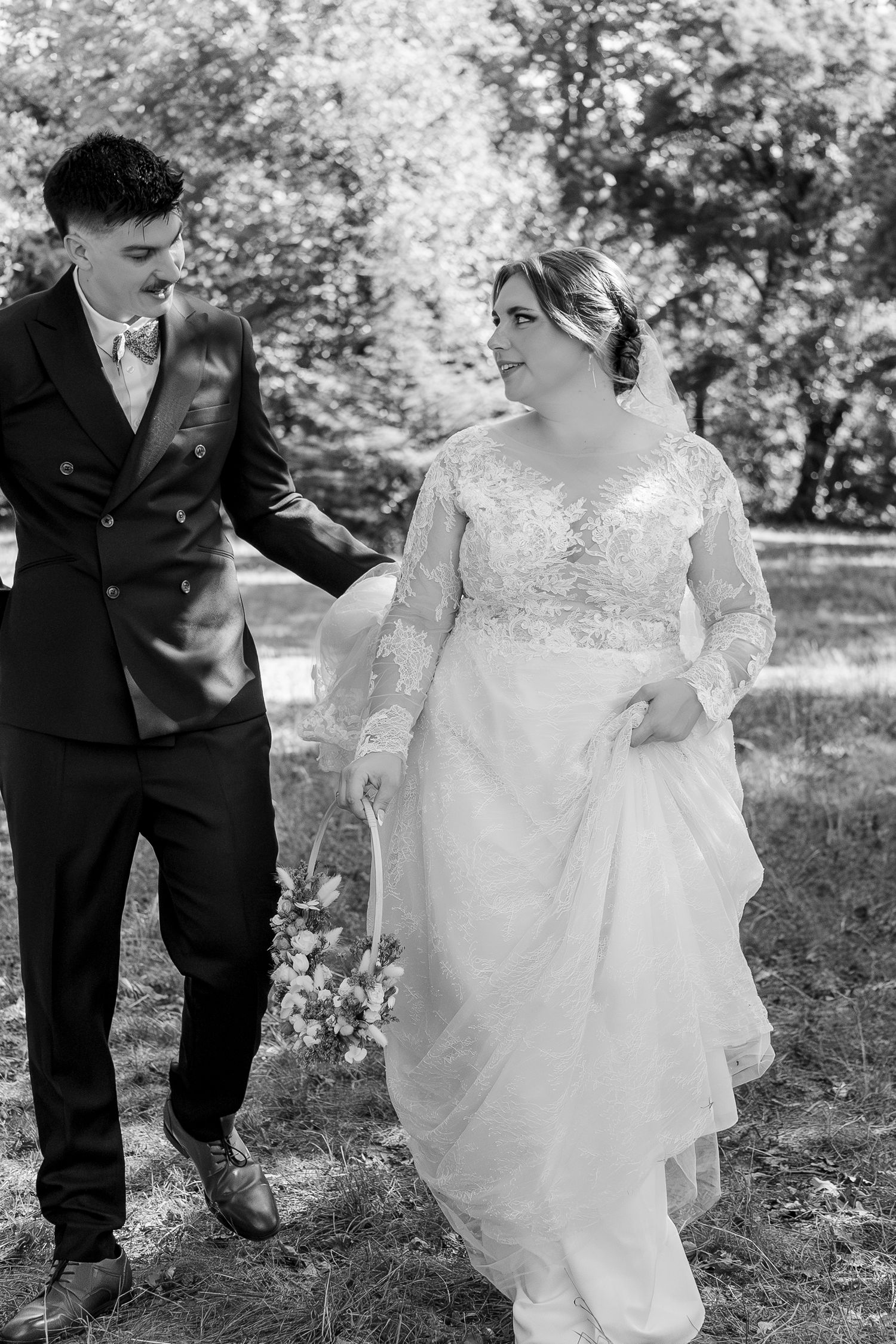 Black and white wedding photos showing couple walking together through a garden setting.