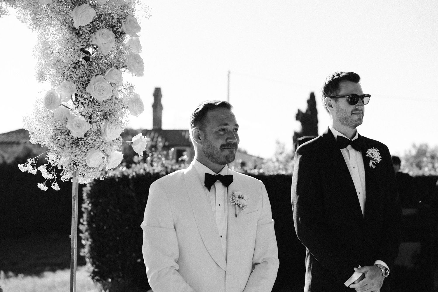 Black and white photos of formal wedding party members gathered outdoors under trees.