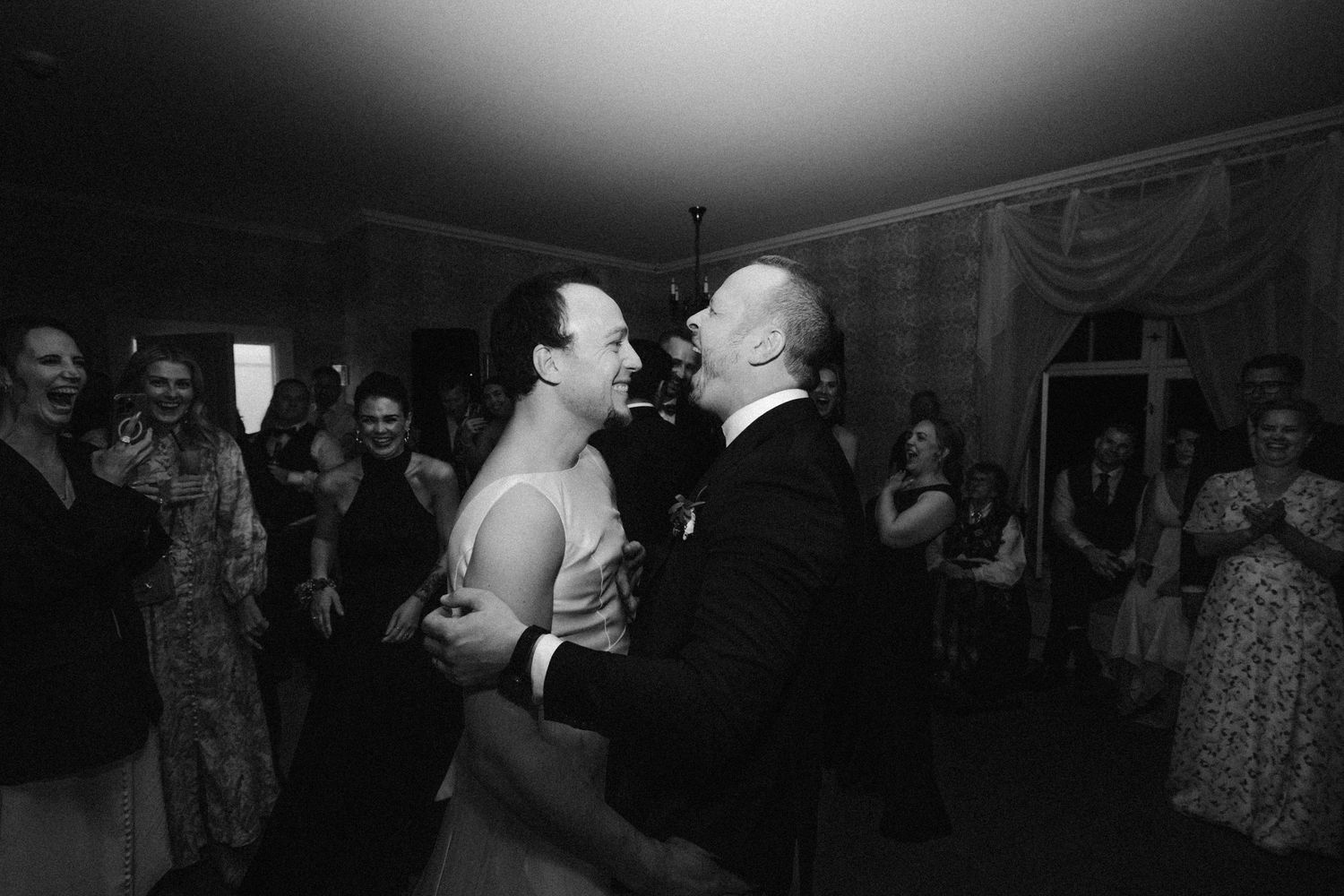 Wedding reception dance floor moments captured in moody lighting.