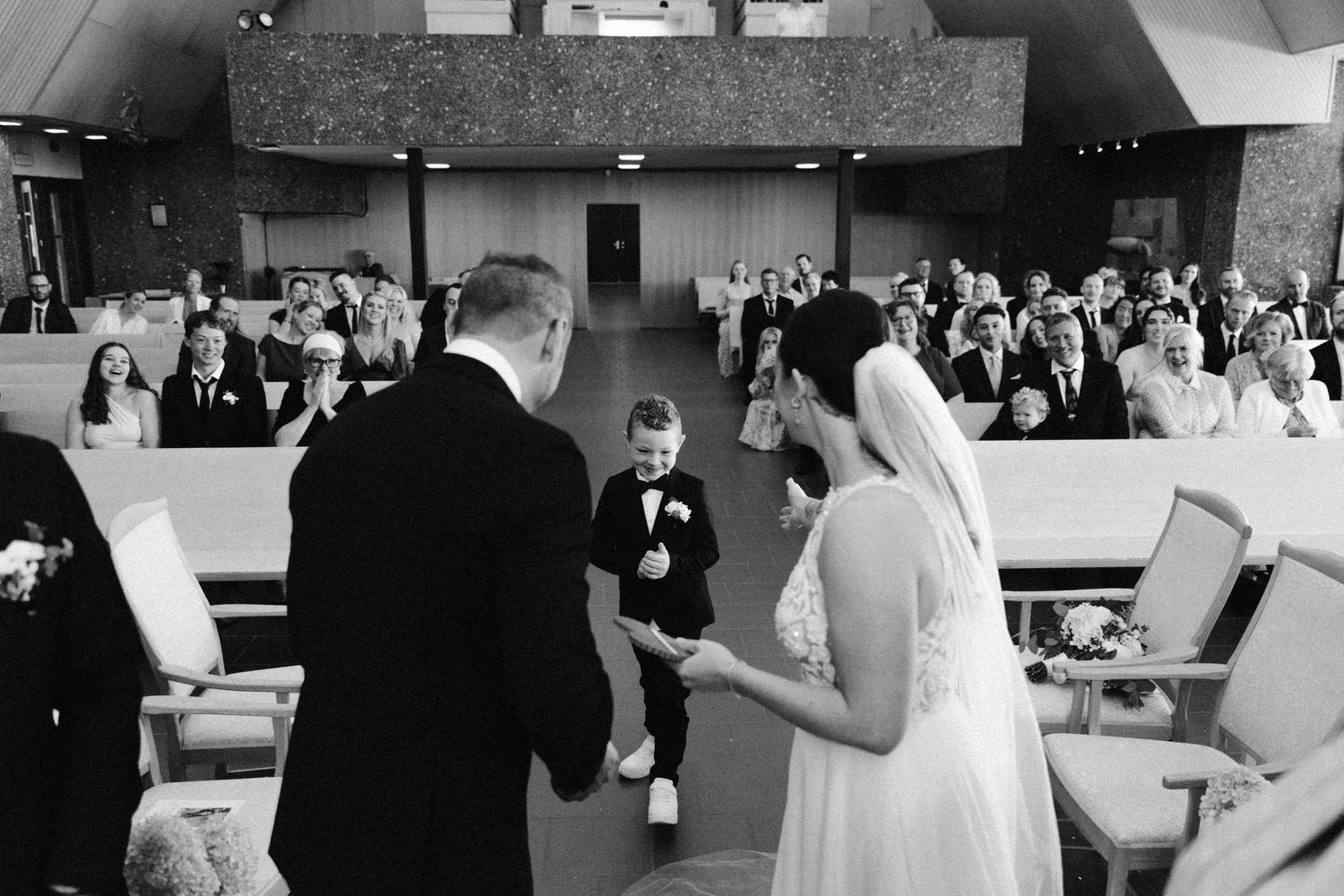 Wedding reception scenes showing dancing and celebration moments in black and white.