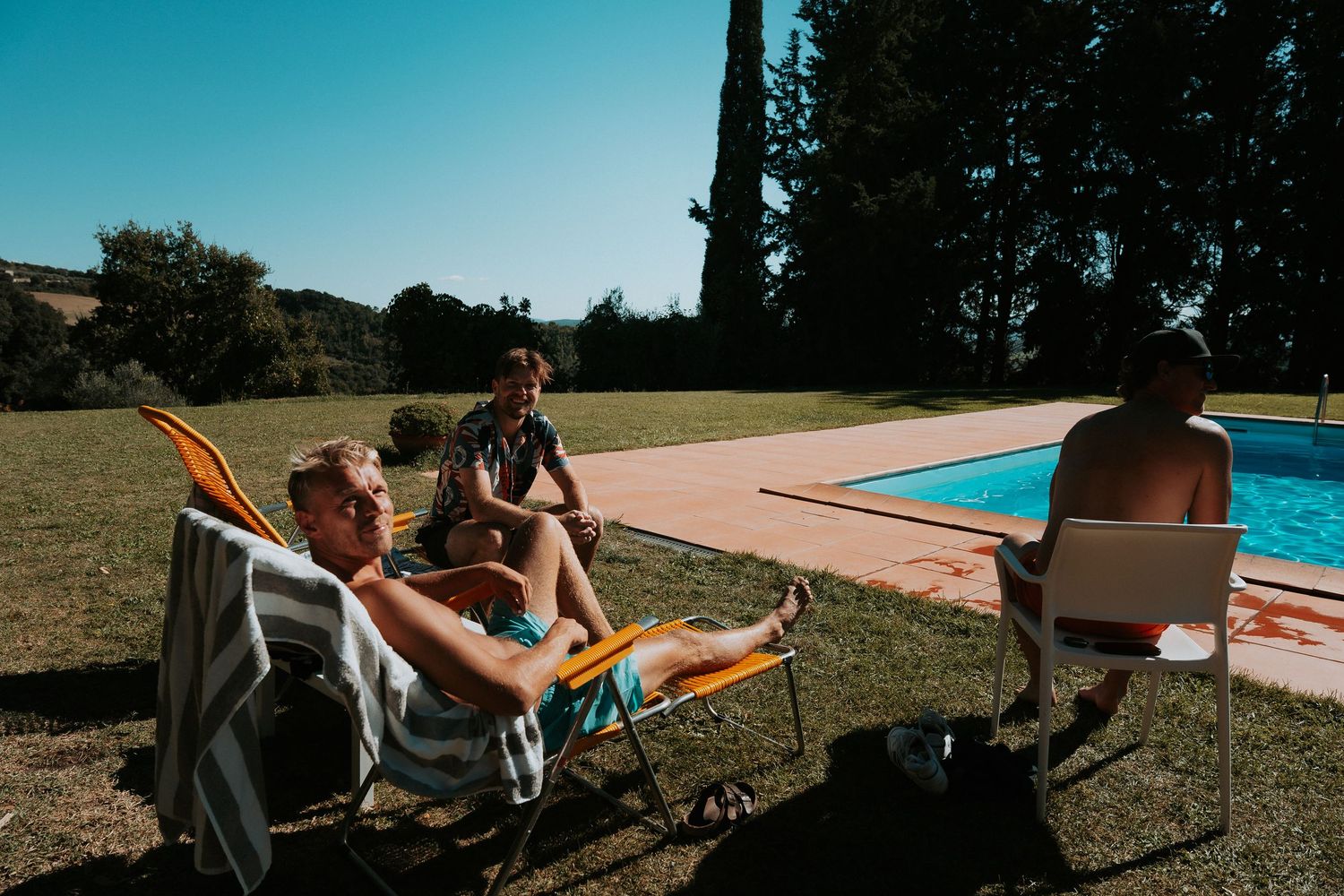 Poolside activities and relaxation at an outdoor venue with mountain backdrop.