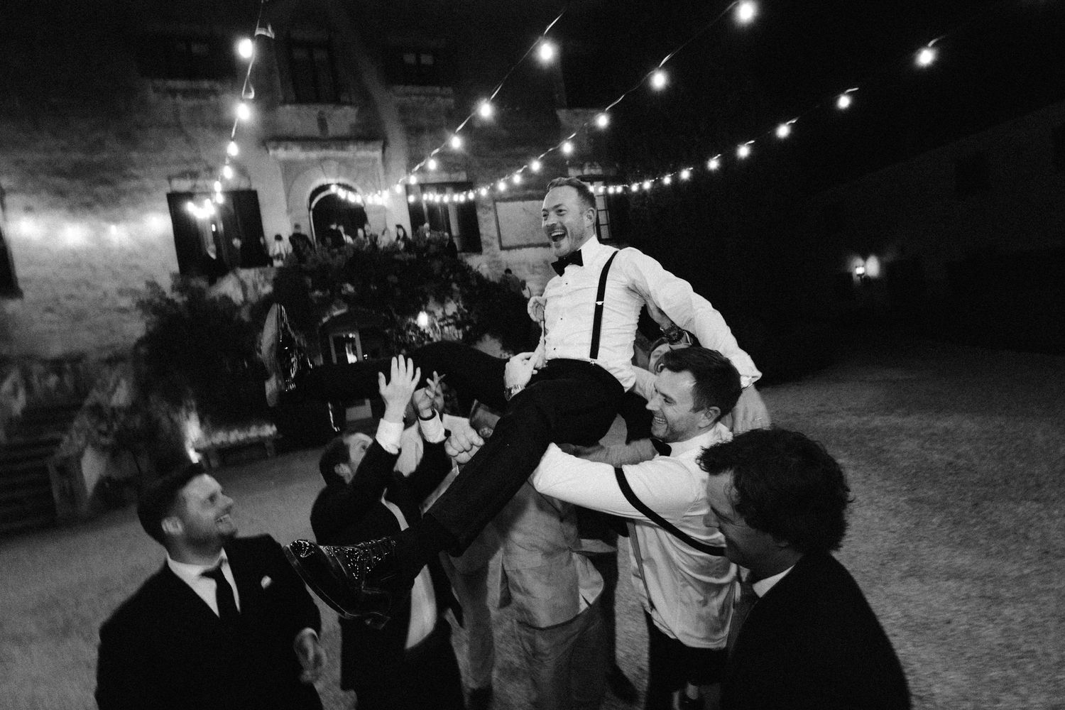 A black and white photo strip showing multiple candid party scenes with string lights and people dancing and socializing.