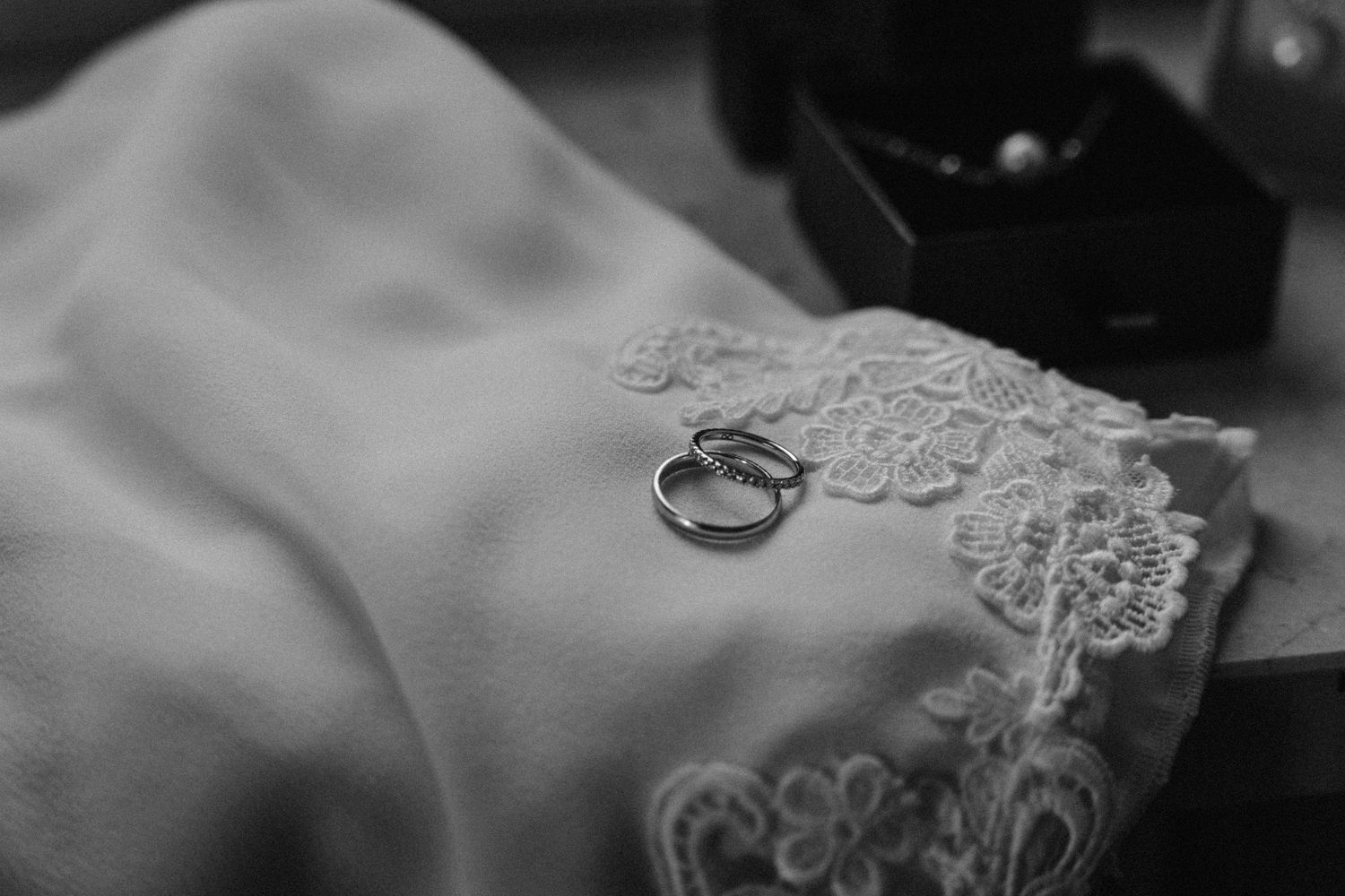 Close-up detail of delicate white lace fabric with intricate patterns.