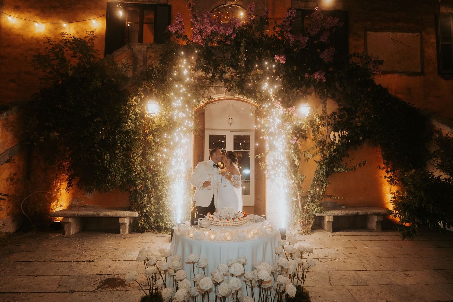 Elegant wedding venue decorated with floral arrangements and ambient lighting creating a magical atmosphere.