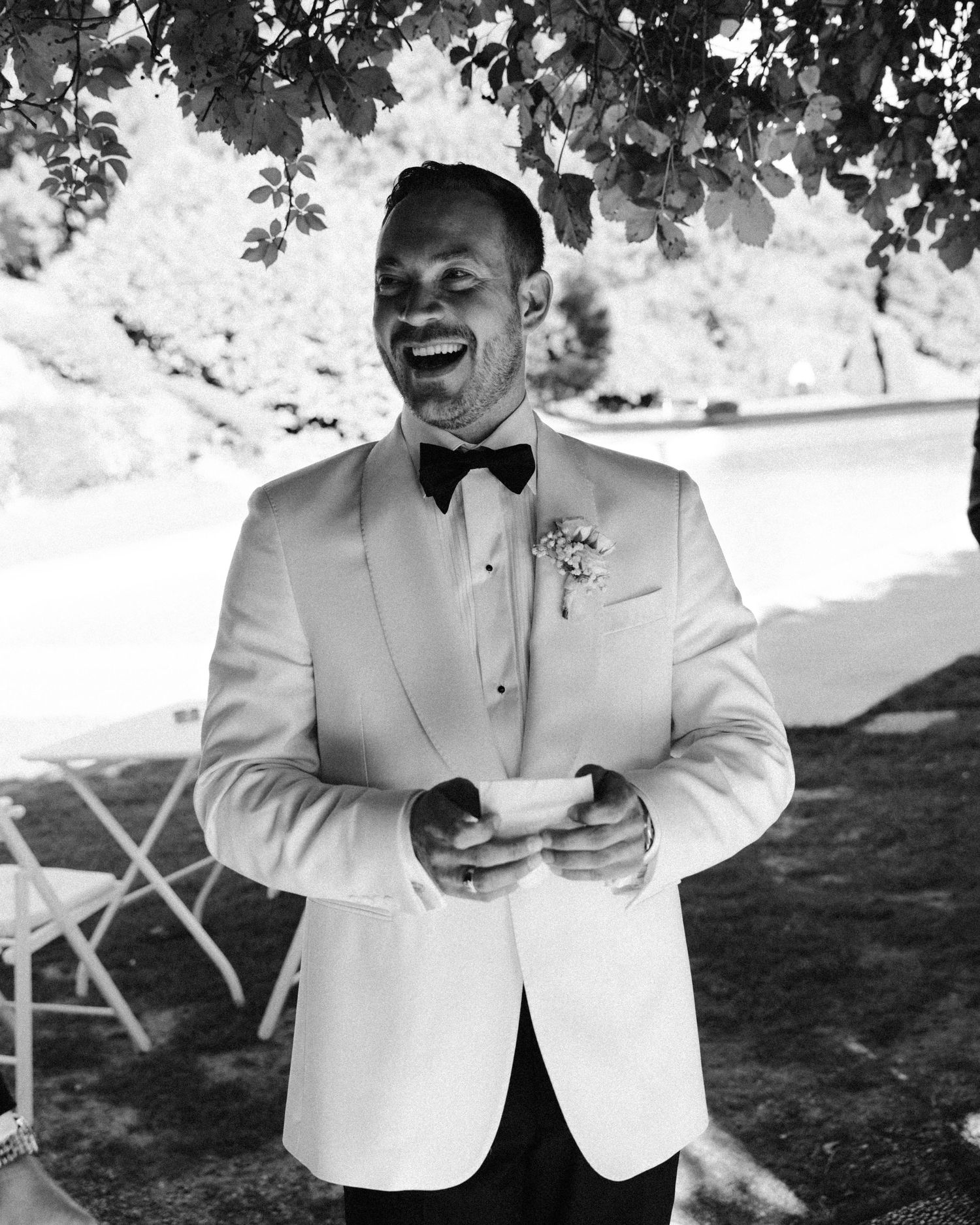 A series of moments showing someone adjusting their white formal jacket and bowtie outdoors.