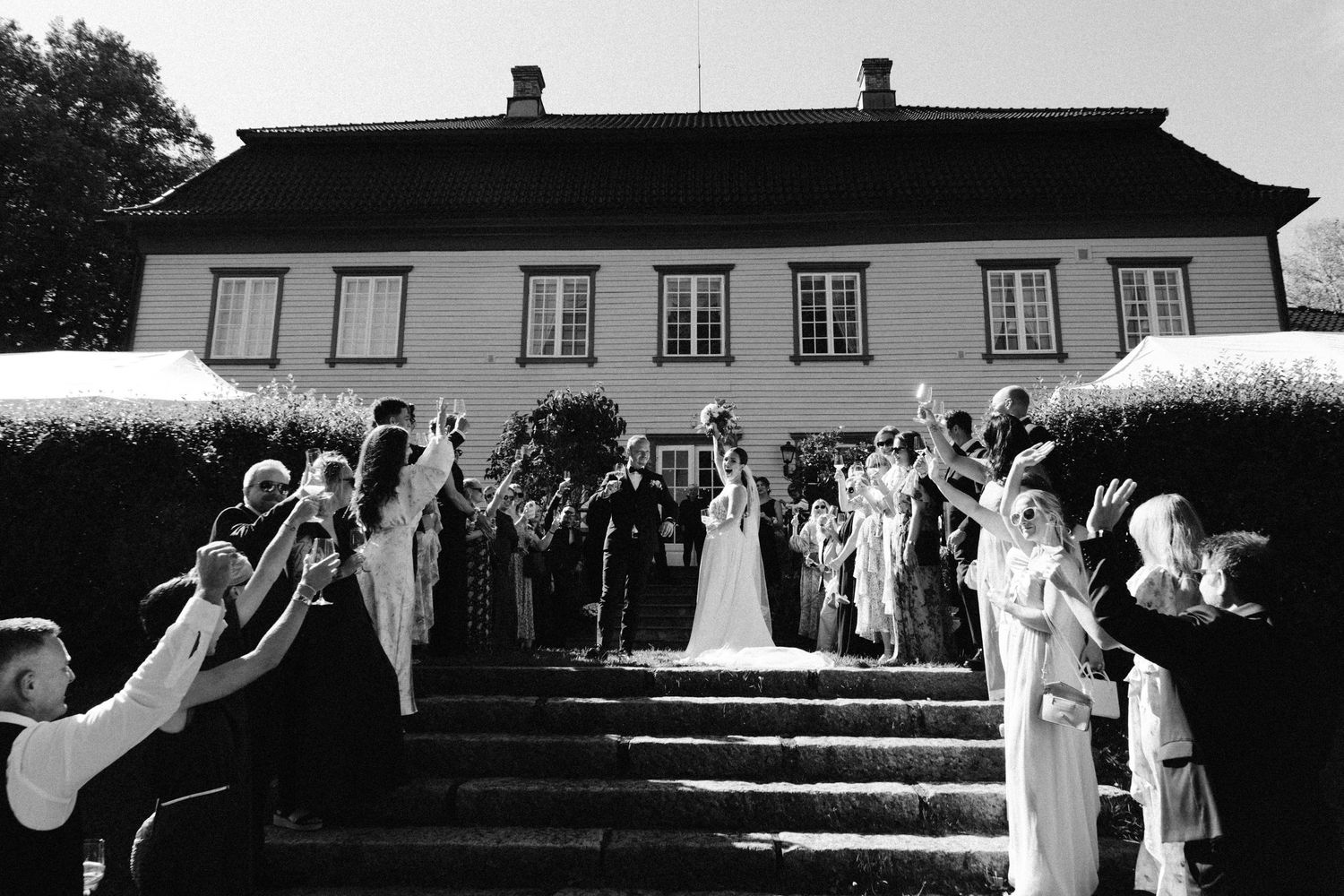 A series of black and white wedding celebration photos showing joyful moments during a reception.