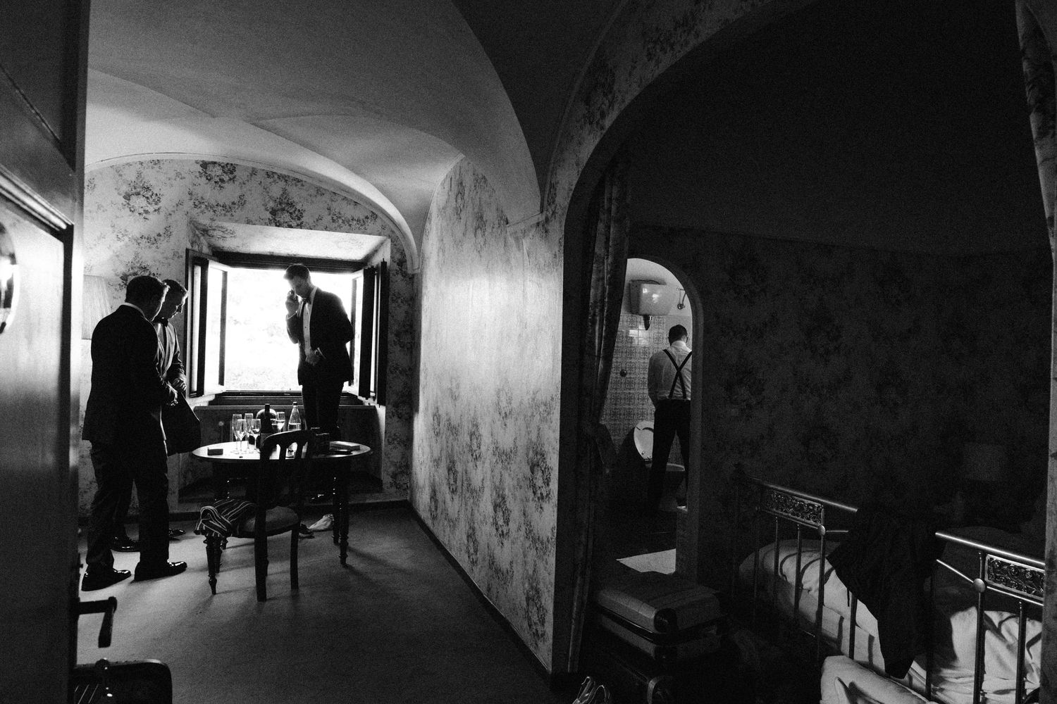 Dark atmospheric hallway with arched architecture and dramatic lighting.