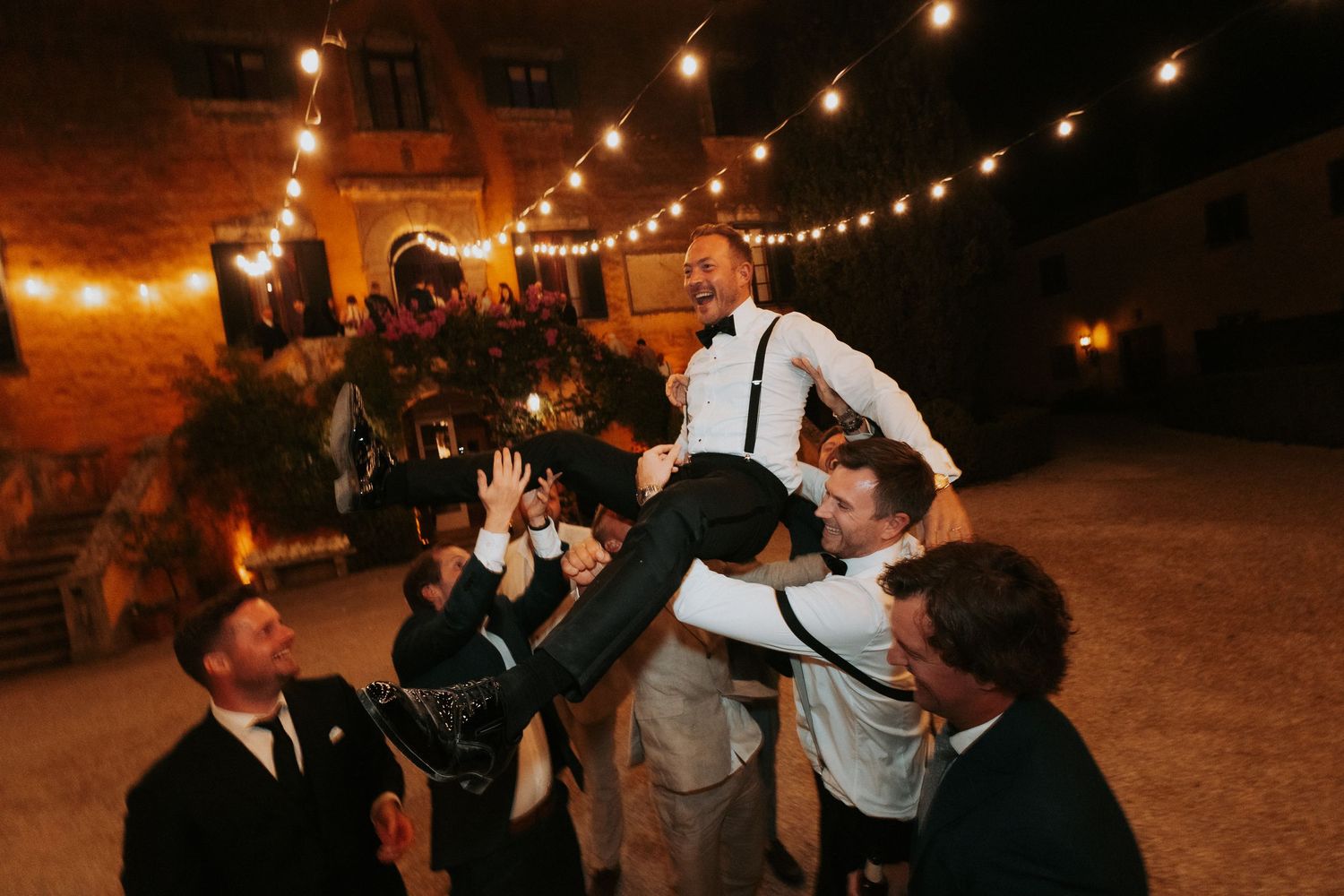 Evening outdoor reception with warm string lights creating a romantic ambiance.