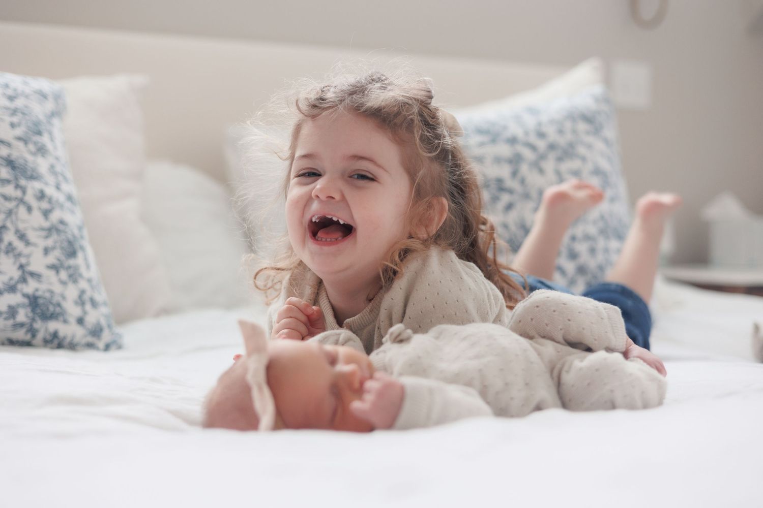 siblings, newborn, sisters, in home, giggling, north shore massachusetts