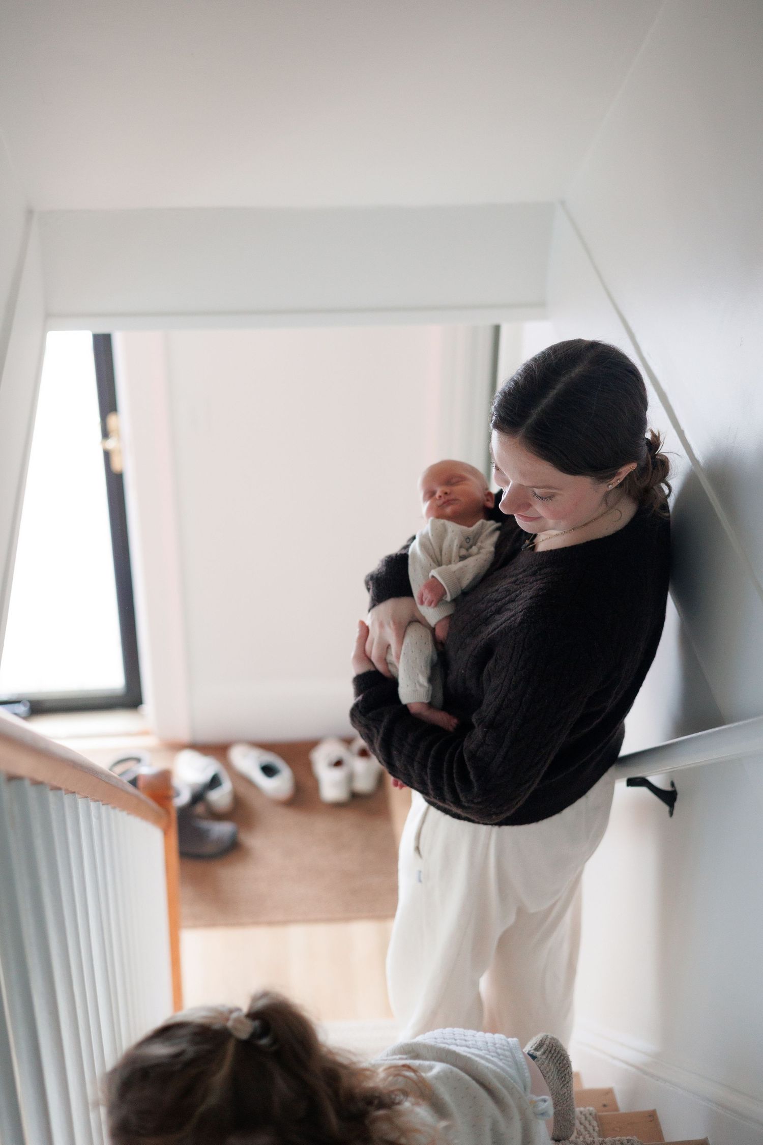 newborn, in home, mother holding baby, staircase, documentary, north shore massachusetts