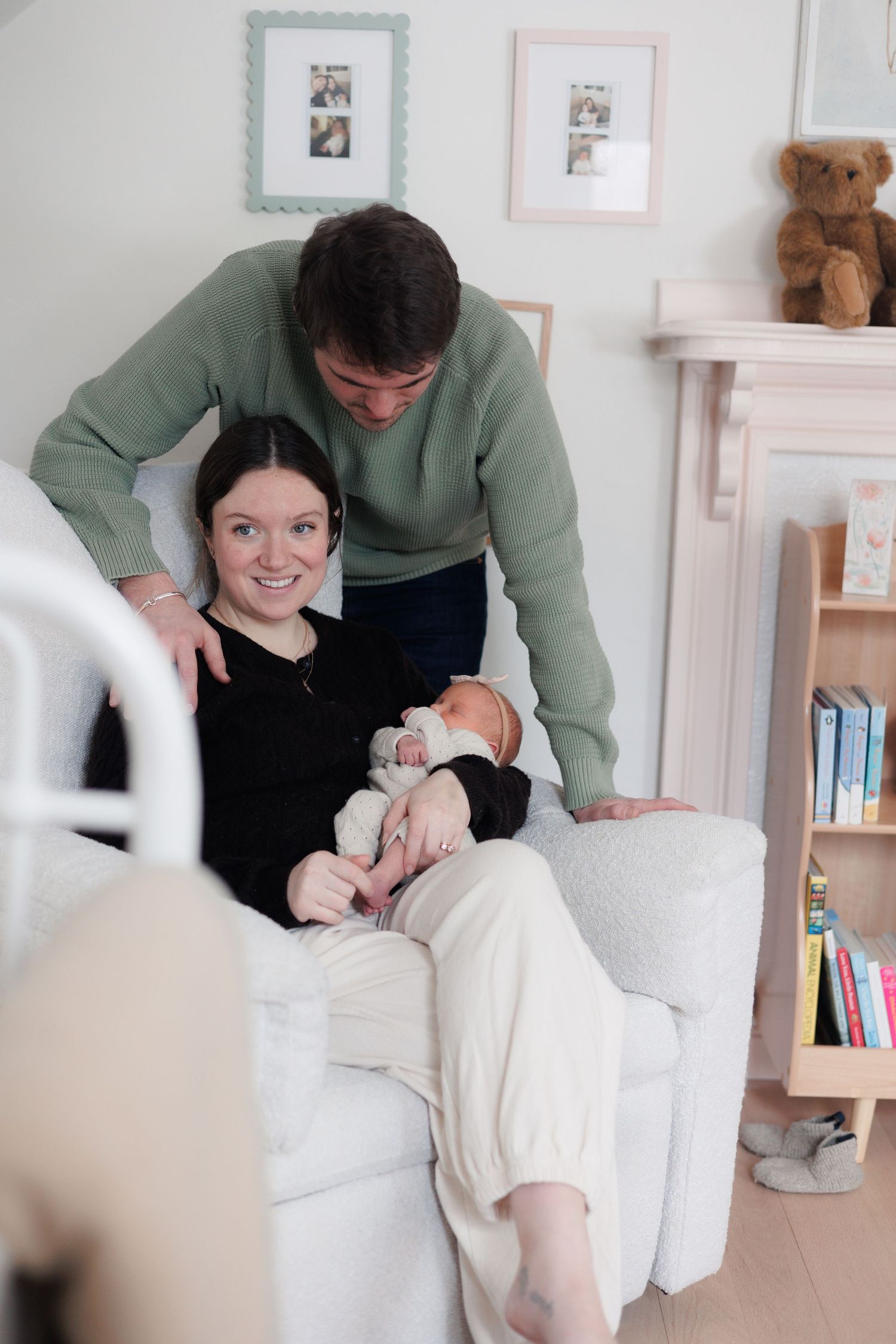 family in baby nursery, glider, newborn, bookshelf, north shore massachusetts