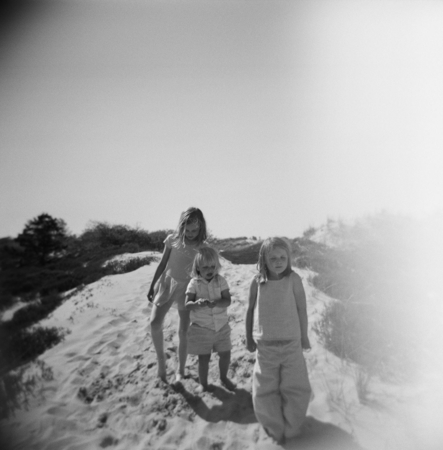 Black and white photos show people playing and having fun in sand dunes, ipswich massachusetts