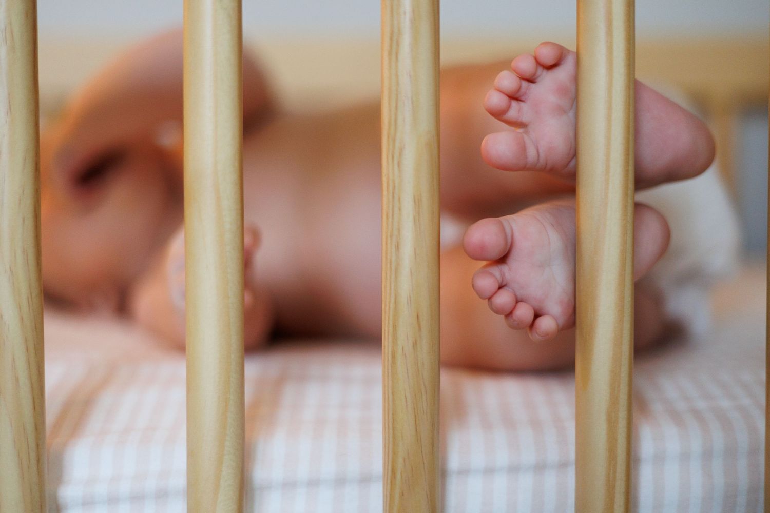 baby toes on crib, in home session, newborn session, north shore massachusetts