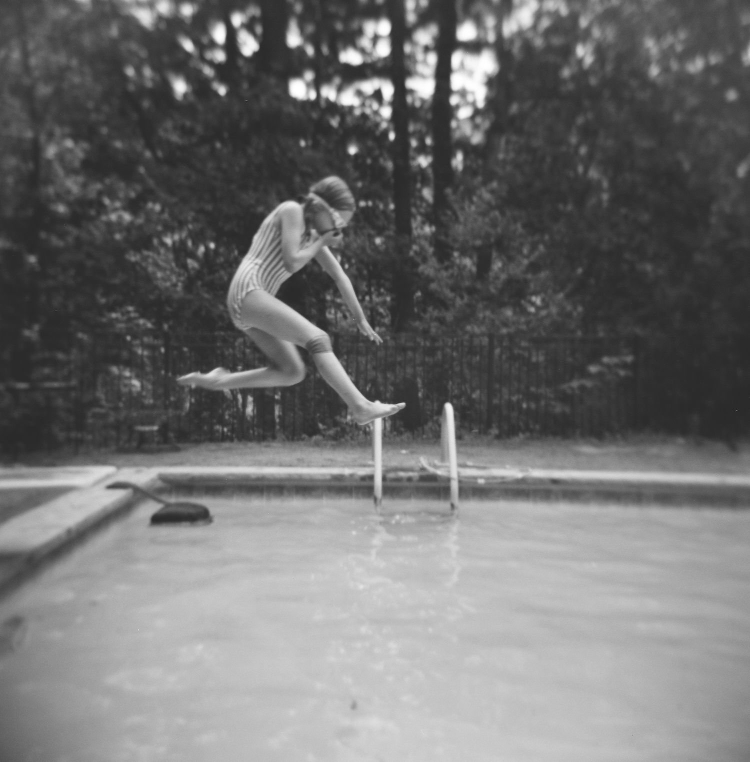 child jumping into pool, black and white photo, summertime, goggles, north shore massachusetts