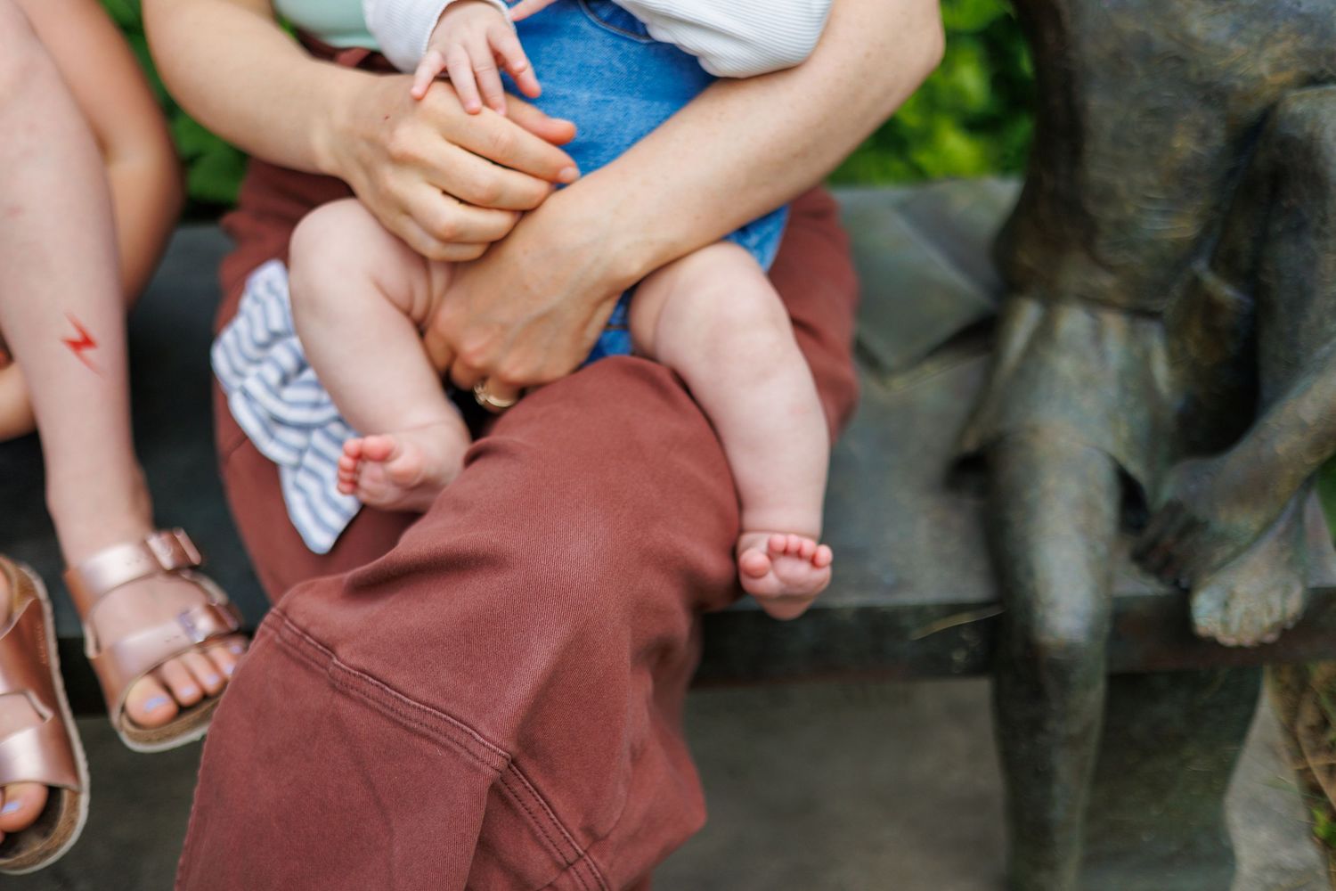 family photo, faceless photo, mom holding baby on lap, arms and legs intertwined, north shore massachusetts