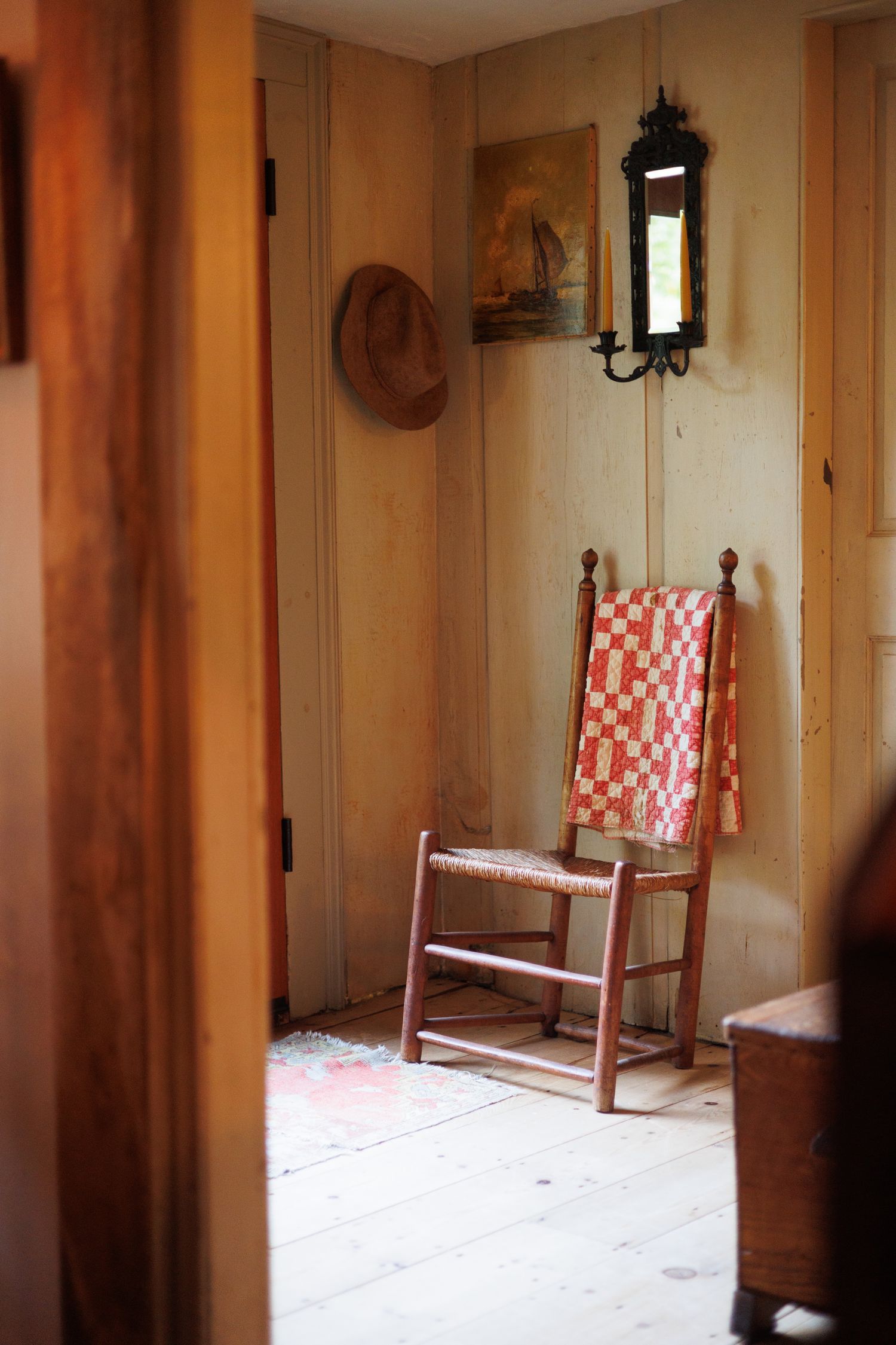 Empty rustic room interior with wooden walls and red and white checkered chairs against the wall. north shore massachusetts