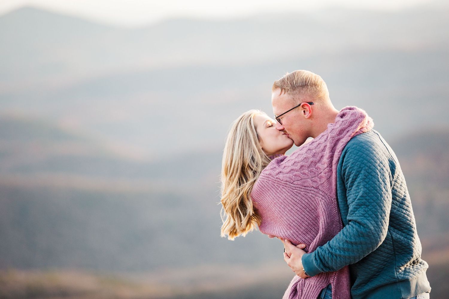 Intimate moment captured between couple on mountain summit during golden hour Boone NC Engagement Photographer on the Blue Ridge Parkway