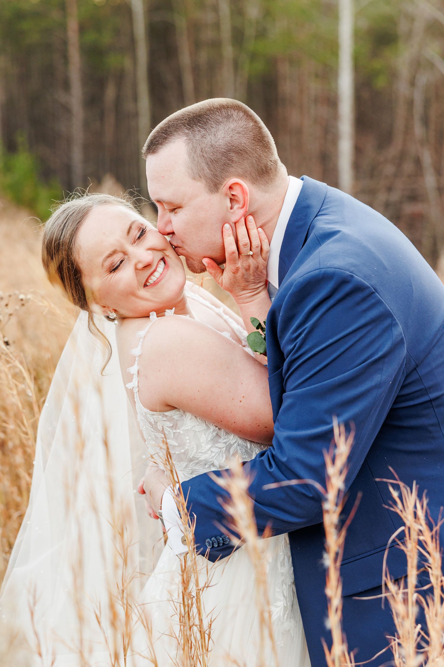 Intimate wedding portrait among tall grasses and natural scenery at Serre Vineyards with NC wedding photographer