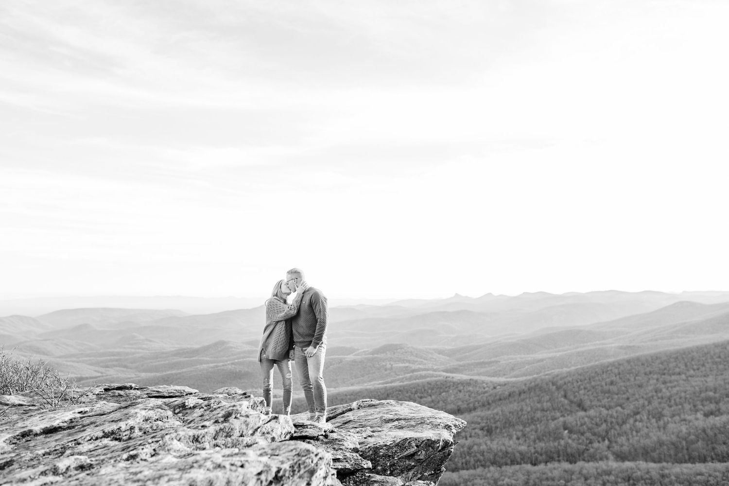 Panoramic mountain landscape with couple silhouetted on rocky overlook Boone NC Engagement Photographer on the Blue Ridge Parkway