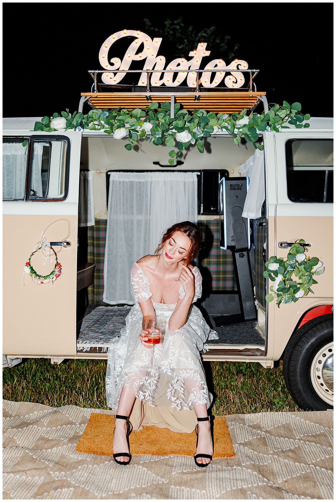 Vintage photo booth setup with decorative greenery and lights for wedding reception with direct flash NC Wedding Photographer