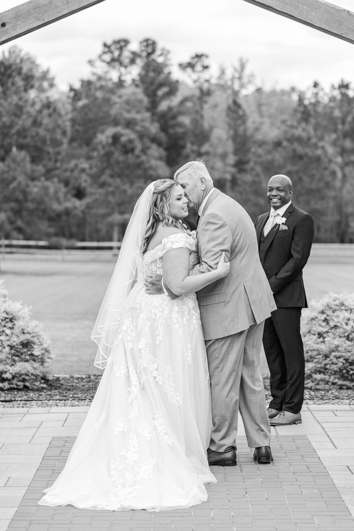 A touching moment between newlyweds during their outdoor wedding ceremony.