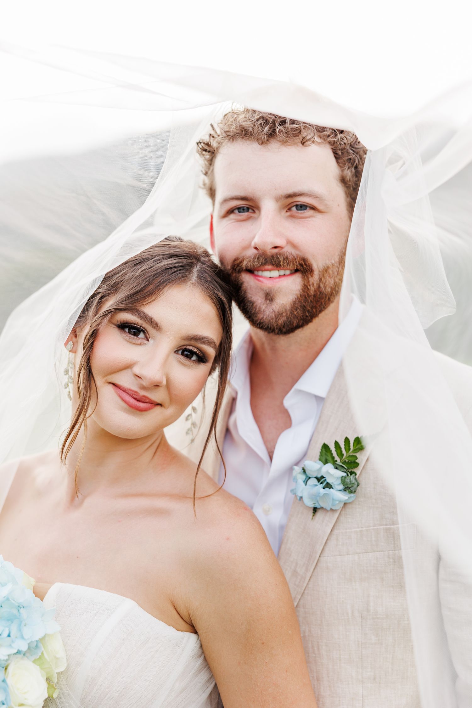 Romantic wedding portraits under flowing white veil with soft natural lighting with North Carolina Wedding Photographer
