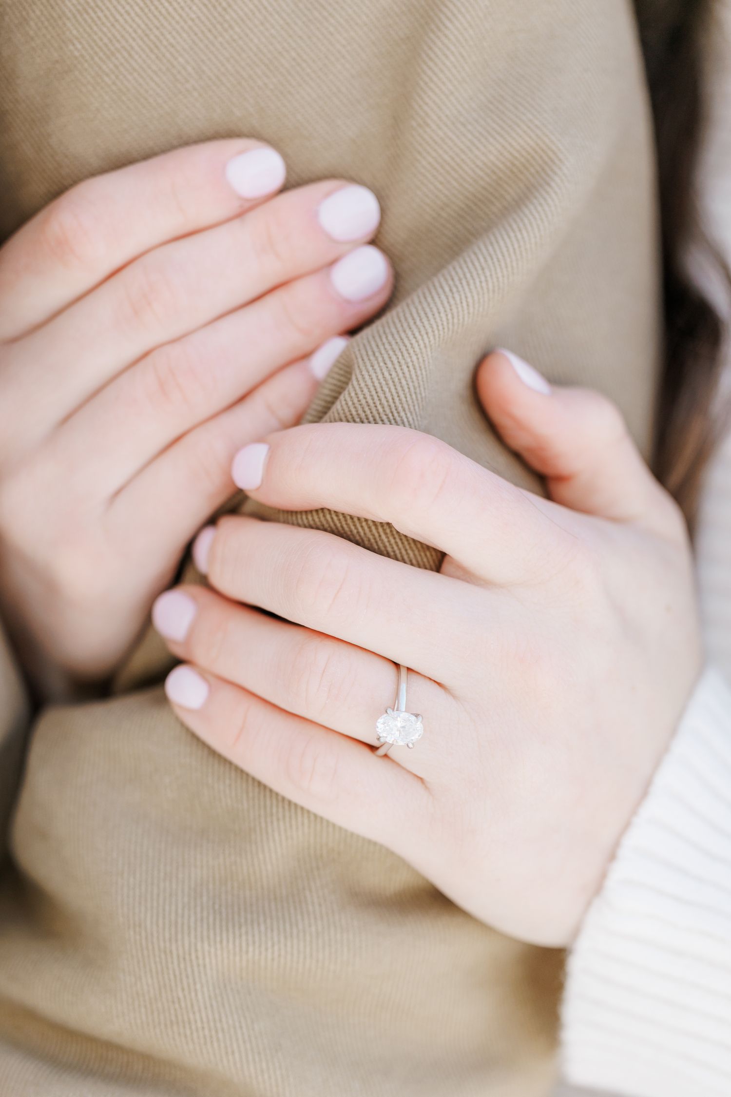 Close up of hands showing off an engagement ring with white nail polish with Winston Salem Engagement Photographer