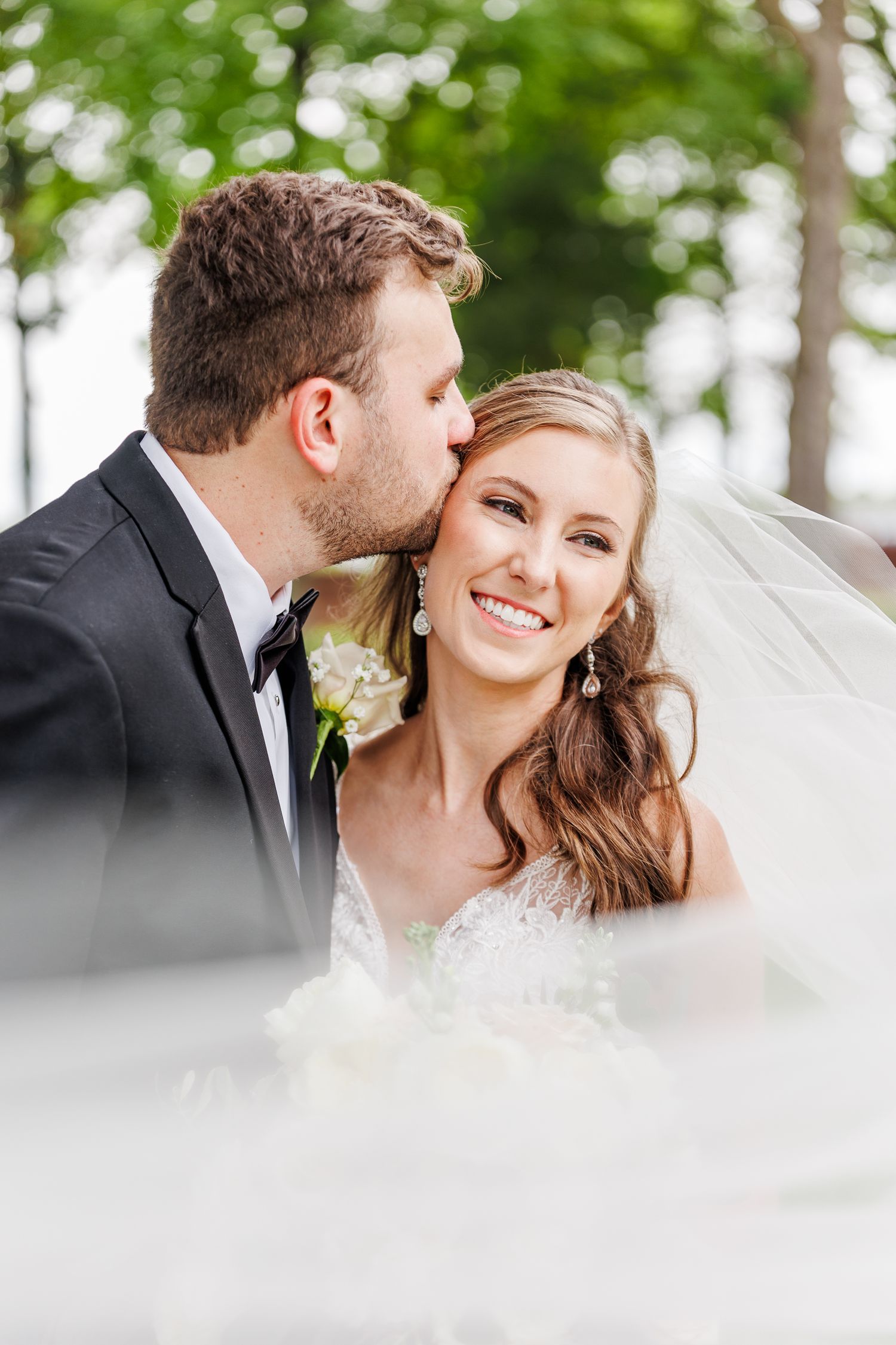 Romantic wedding portrait with soft bokeh effect and natural greenery in the background at the Brawley Estate Wedding Venue
