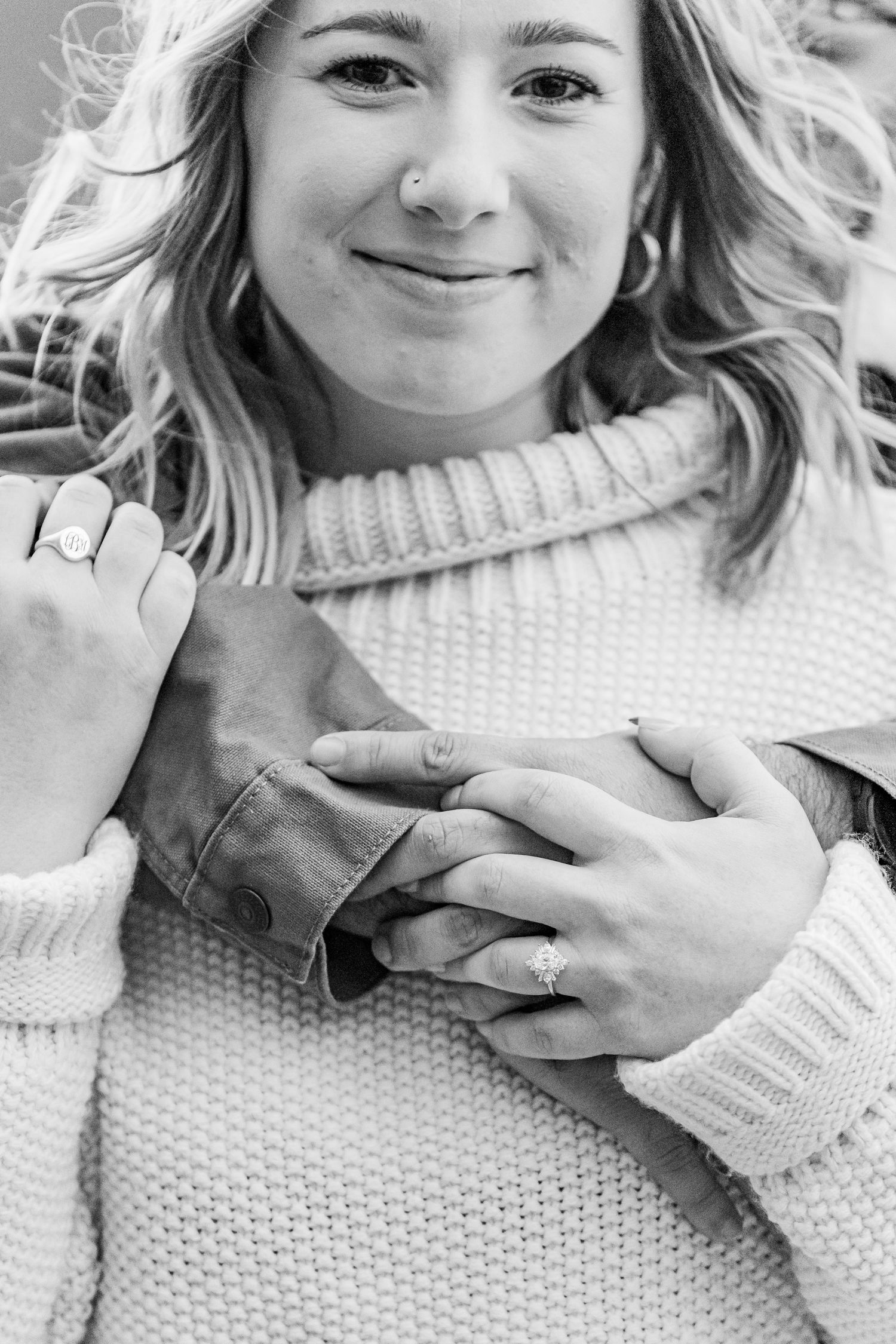 Close-up portrait showing person in cream turtleneck sweater with engagement ring at Hanging Rock State Park