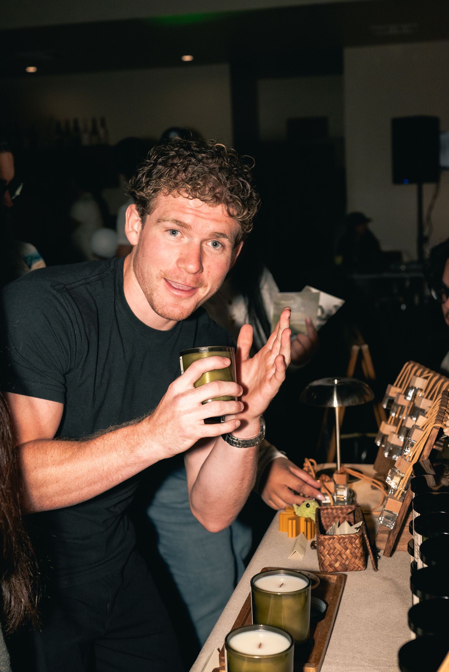 Portrait of a man holding one of the candles at the store popup.