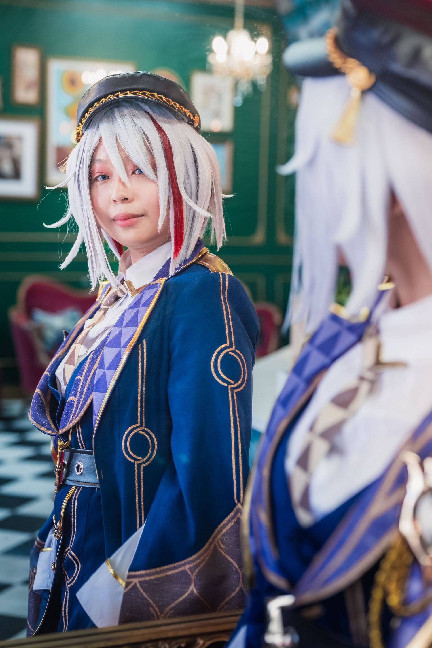 Portrait of the reflection of a woman cosplaying as Topaz from Honkai: Star Rail looking into the camera