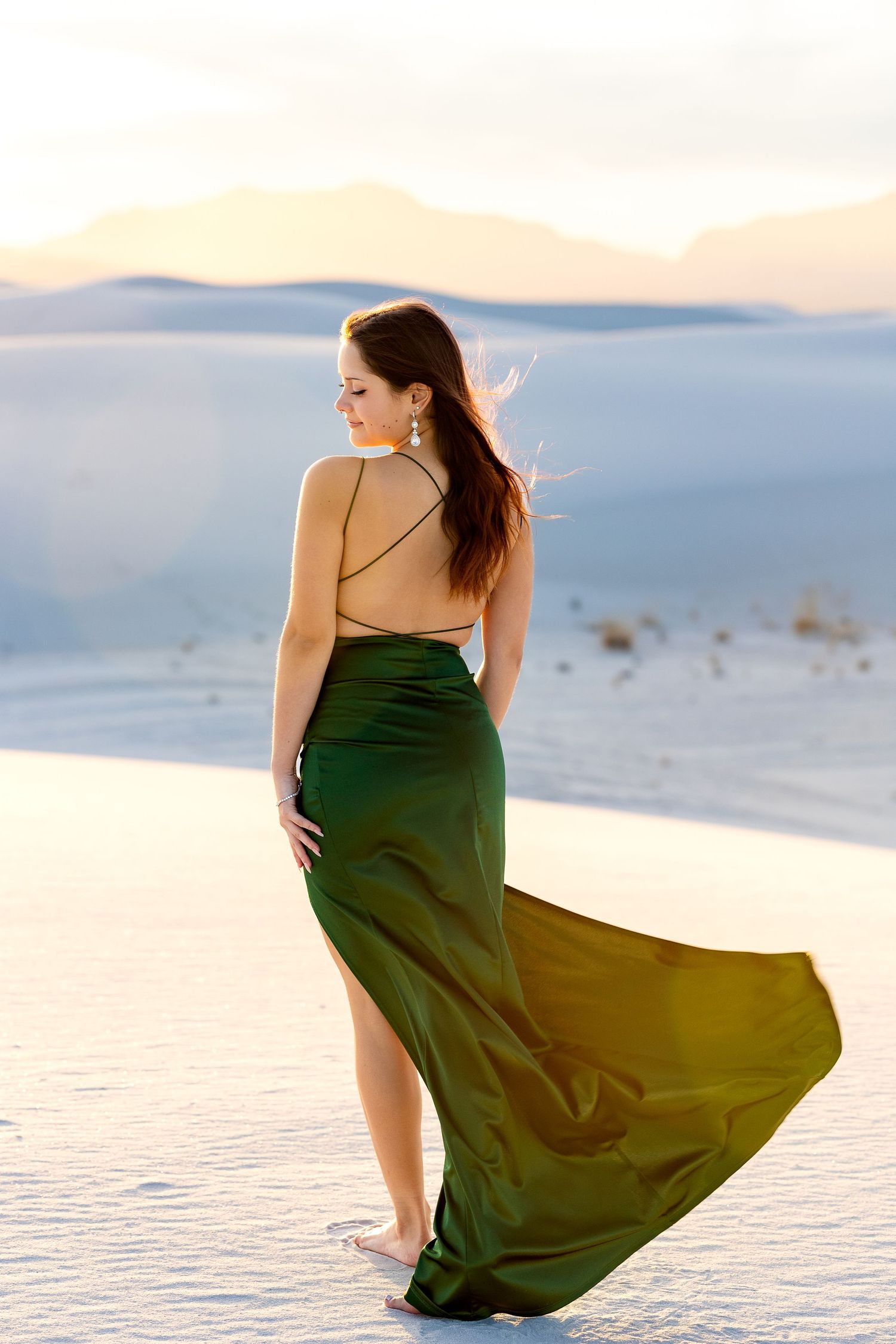 High School senior during her Senior pictures in long green gown at White Sands National Monument.