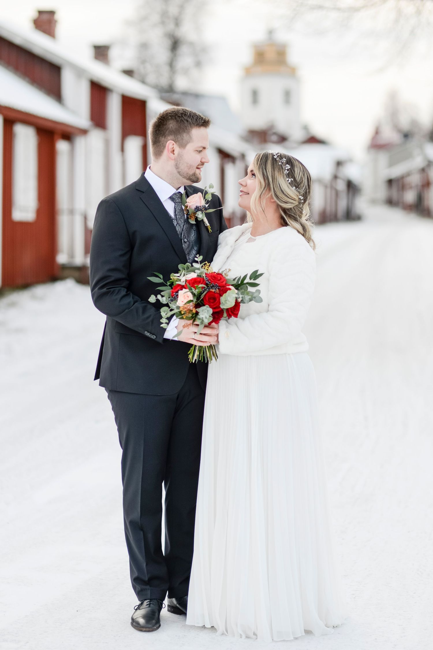 Elegant winter wedding photos showing couple in black and white against snowy landscape.