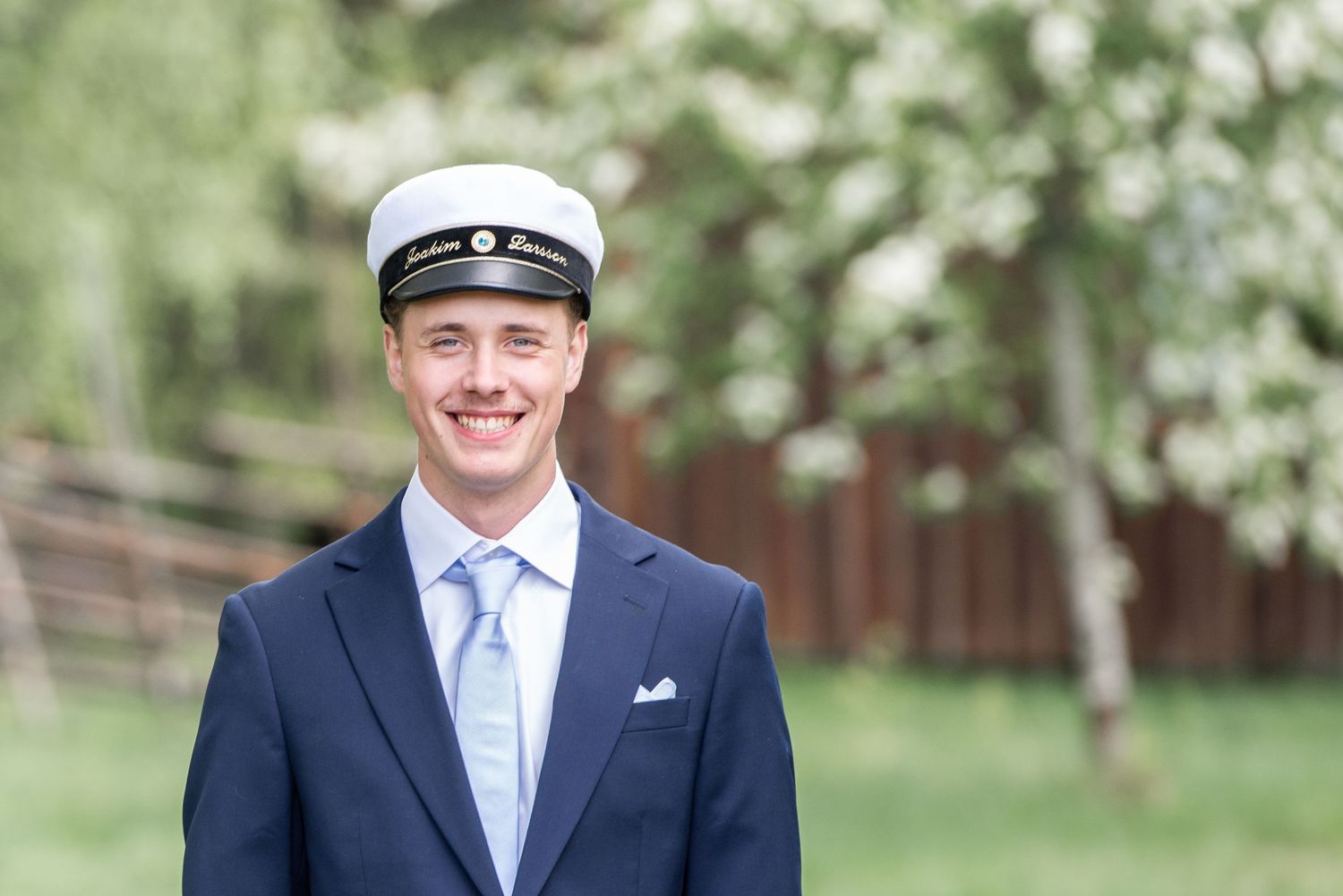 Spring graduation photos captured in a blooming garden setting.