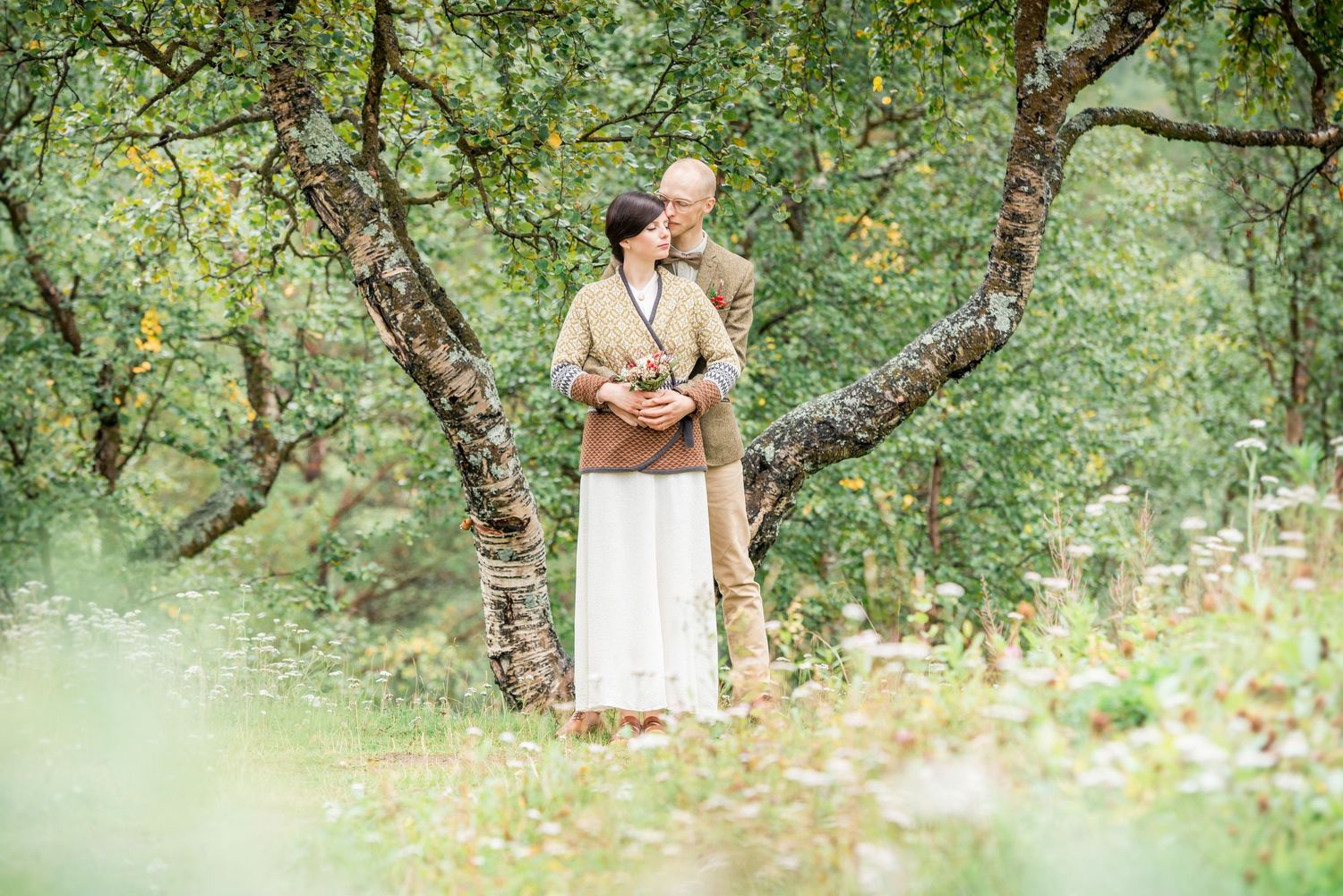 Romantic outdoor photography session in a green orchard setting.