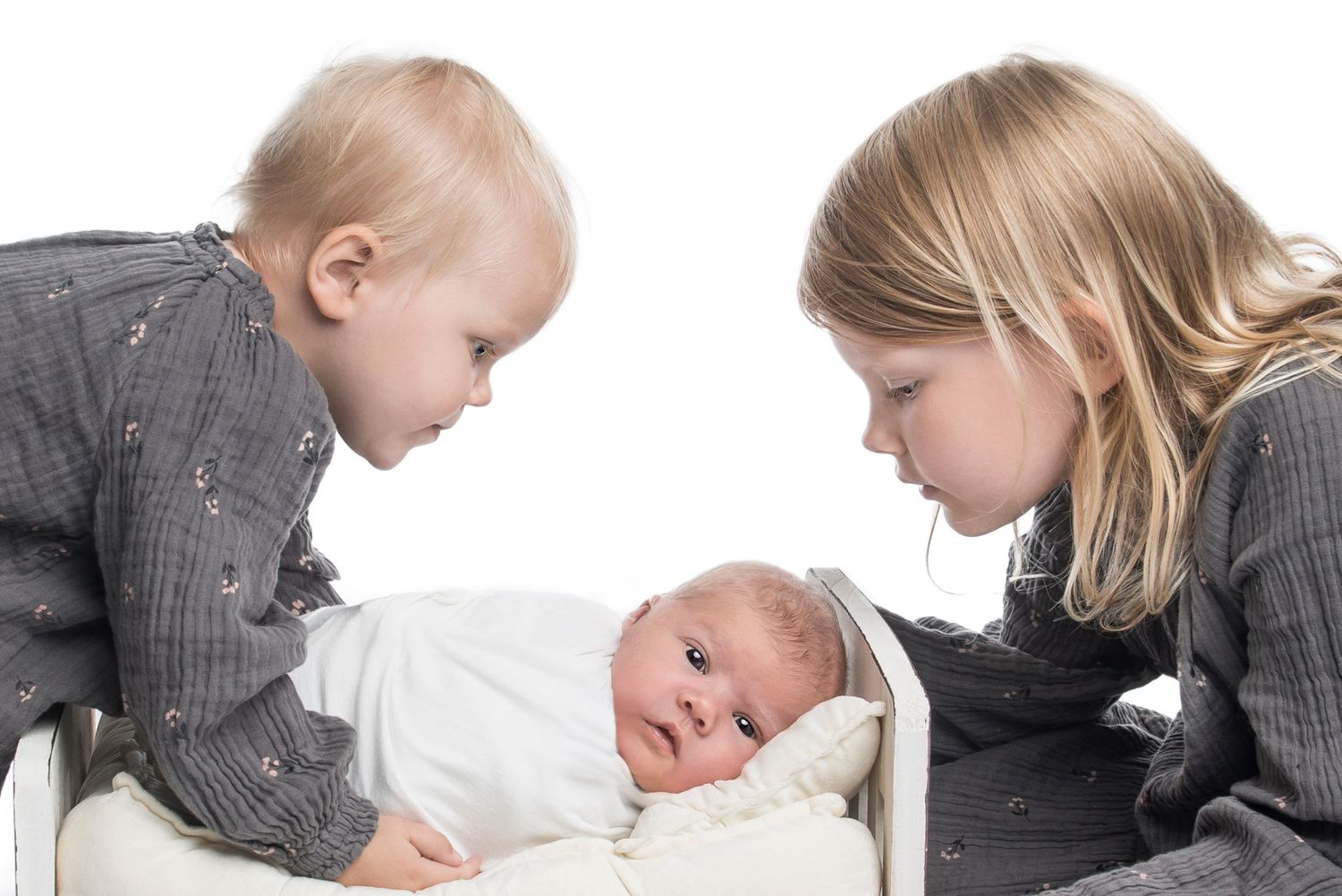 Series of tender moments showing interaction with sleeping newborn.