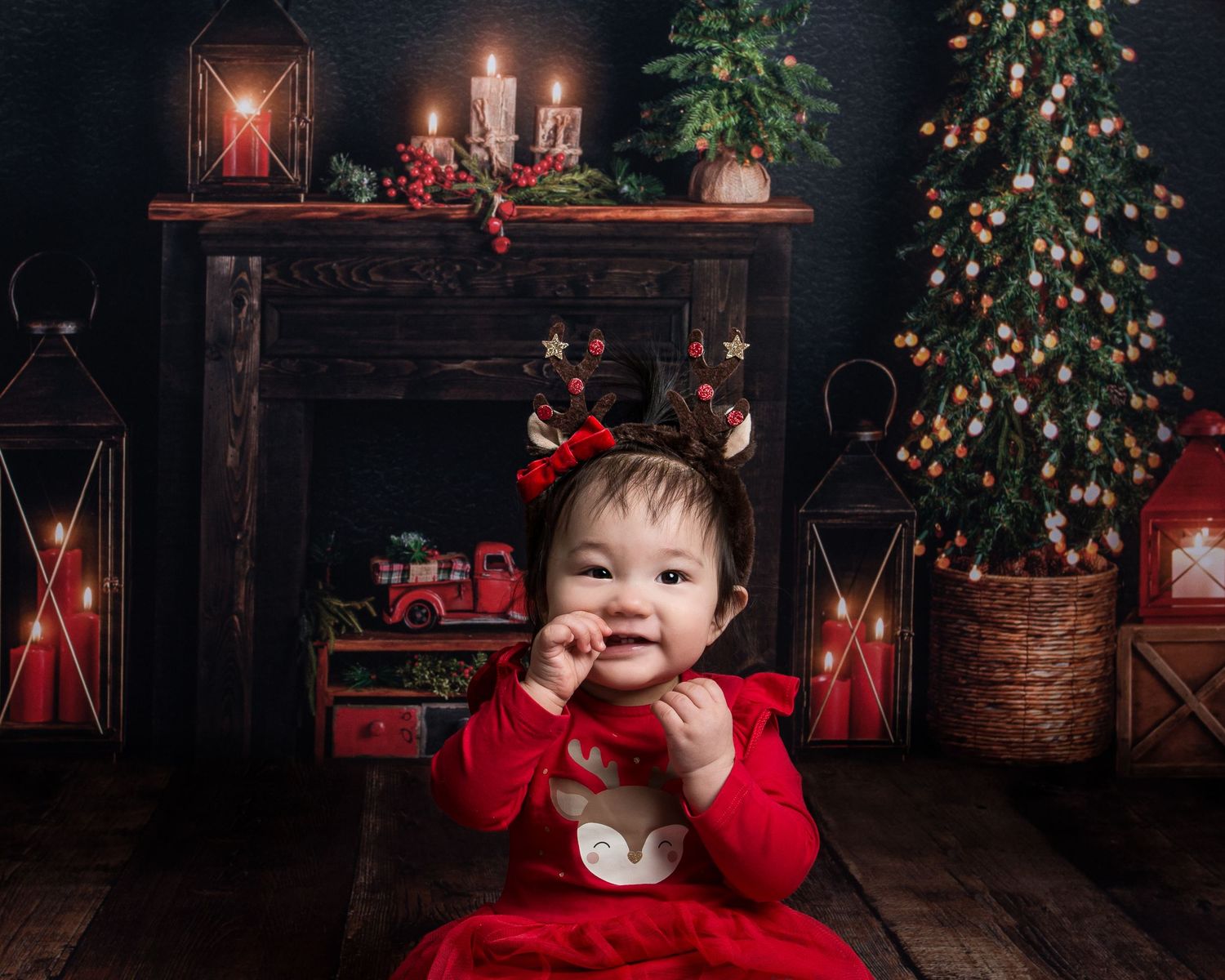 Rustic Christmas scene with glowing lanterns, decorated trees and red holiday accents.