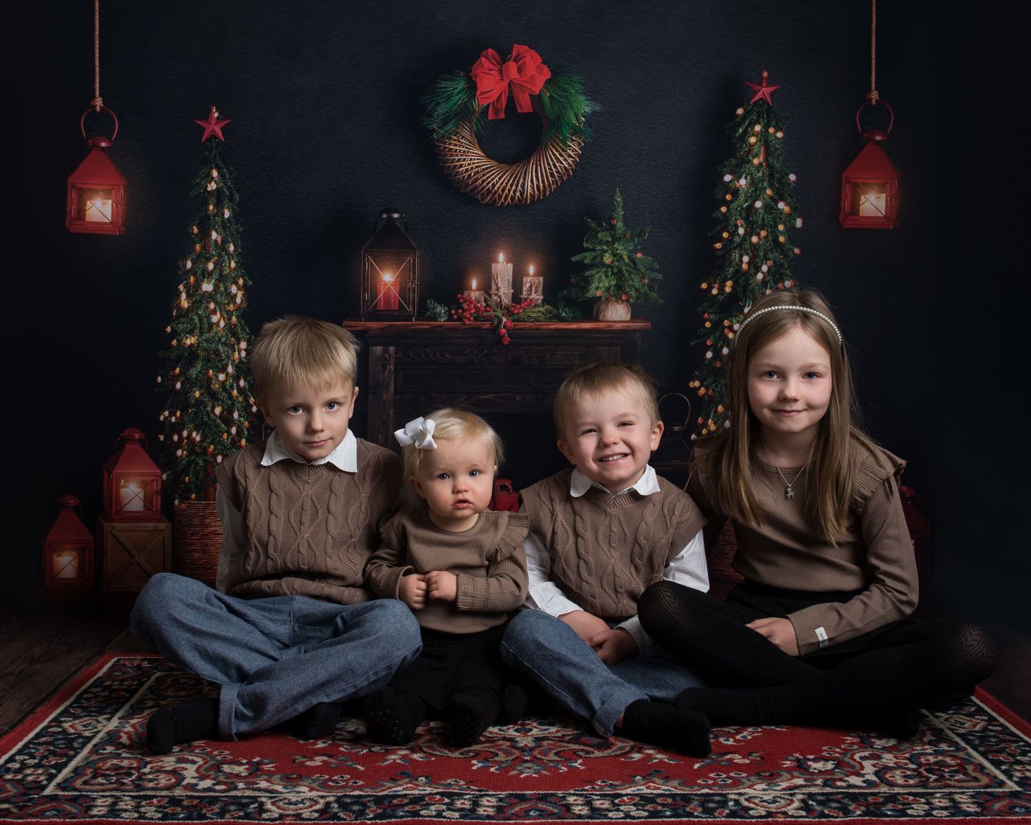 Dark and moody Christmas photo setting with red accents and holiday decorations on rustic wood floors.